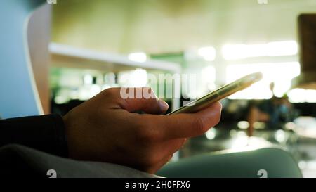 femme mains avec le téléphone à l'aéroport. chat, appel vidéo, social. Banque D'Images