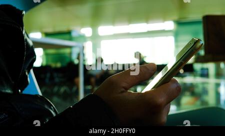 femme mains avec le téléphone à l'aéroport. chat, appel vidéo, social. Banque D'Images