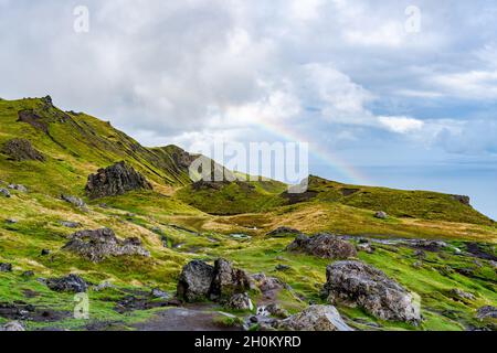 Vue depuis le vieil homme de Storr avec des nuages bas et un arc-en-ciel sur le détroit de Raasay, île de Skye, Écosse Banque D'Images