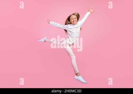 Photo de la petite dame inspirée saut profiter de l'air porter des vêtements de pyjama à pois chaussures de pyjama isolé couleur rose fond Banque D'Images