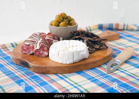 en-cas simple avec camembert, olives et pain au jambon sur fond bleu, style rétro Banque D'Images