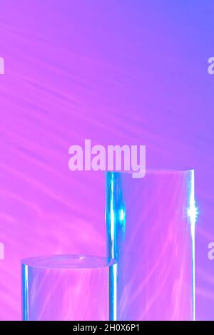 trois podiums en verre transparent sur fond rose pastel Banque D'Images