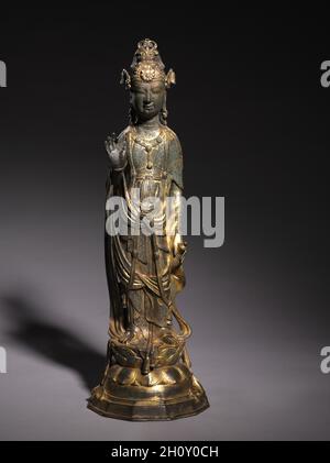 Bodhisattva Guanyin, 900s.Chine, dynastie Liao (916-1125).Bronze doré; total: 43.8 cm (17 1/4 po); diamètre de la base: 14.6 cm (5 3/4 po).Dans le bouddhisme, un bodhisattva est un être qui, juste avant d'atteindre l'illumination, se retourne pour aider les autres à atteindre l'illumination d'abord.Ce bodhisattva tient sa main paume vers l'avant, dans un geste qui dit aux disciples de ne pas craindre.D'autre part, il porte une bouteille qui contient l'élixir de l'immortalité. Banque D'Images