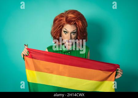 Drag queen célébrant la fierté gay tenant le drapeau arc-en-ciel - concept de communauté sociale LGBTQ Banque D'Images