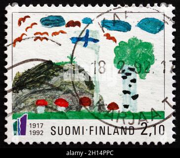 FINLANDE – VERS 1992 : un timbre imprimé en Finlande montre la peinture de l’enfant, vers 1992 Banque D'Images