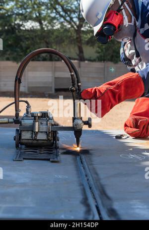 Soudeur Motswana travailleur dans un atelier du Botswana, à l'aide d'un chalumeau pour couper en ligne droite, torche, rouleau Banque D'Images