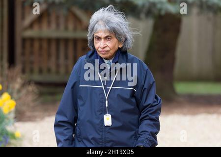 Femme indienne asiatique âgée marchant à l'extérieur en hiver, au Royaume-Uni.Porter des vêtements chauds et un pendentif d'alarme de sécurité personnelle SOS Banque D'Images