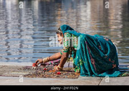 UDAIPUR, INDE - 24 NOVEMBRE 2012: Femme indienne dans Rajasthani vêtements traditionnels vendant des bijoux sur le ghat du lac Pichola, Udaipur, Rajasthan, Ind Banque D'Images