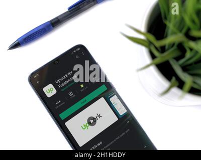 LOD, Israël - 8 juillet 2020 : espace de travail moderne et minimaliste avec smartphone mobile noir avec Upwork for Freelanters application play store page sur blanc b Banque D'Images