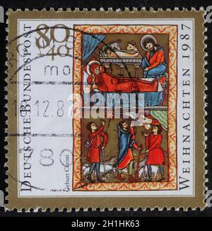 Le timbre de Noël imprimé en Allemagne montre la naissance de Jésus-Christ, adoration des palandes, vers 1987 Banque D'Images