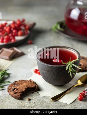 Thé avec baies de viburnum dans un bol, sur une table en bois Banque D'Images