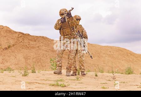 Soldats armés et équipés sur le champ de bataille.Concept d'opérations militaires de lutte contre le terrorisme, opérations spéciales des forces de l'OTAN Banque D'Images