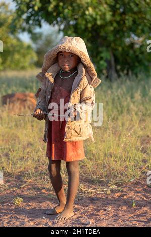 NAMIBIE, RÉGION D'OMUSATI, MAI 7: Fille africaine tôt le matin froid sur la route de la ville d'Opuwo. Namibie du Nord, 6 mai 2018, Namibie Afrique Banque D'Images