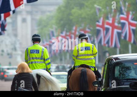 LONDRES, Royaume-Uni - VERS avril 2011 : deux policiers montés sur le Mall, Buckingham Palace en arrière-plan. Banque D'Images