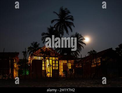Des cabanes de plage sous la pleine lune Banque D'Images
