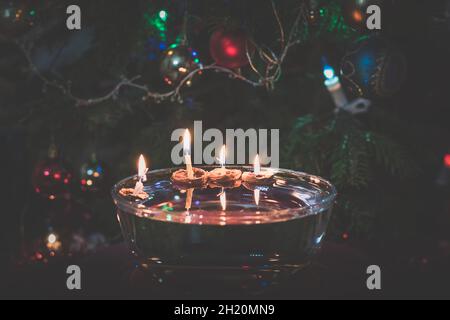 symboles de noël, bougies dans des coquilles de noix flottant sur l'eau, traditions et costumes, espace de copie Banque D'Images