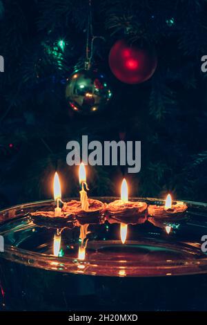 symboles de noël, bougies dans des coquilles de noix flottant sur l'eau, traditions et costumes, espace de copie Banque D'Images