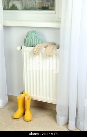 Concept de saison de chauffage avec radiateur et vêtements. Banque D'Images