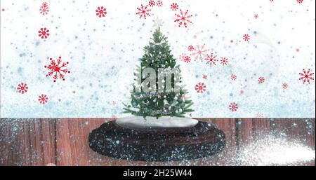 Image de chutes de neige et de taches brillantes sur le globe de neige avec arbre sur fond blanc Banque D'Images