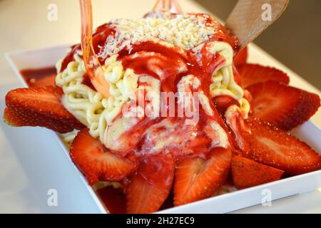 crème glacée spaghetti à la sauce aux fraises et grandes fraises Banque D'Images