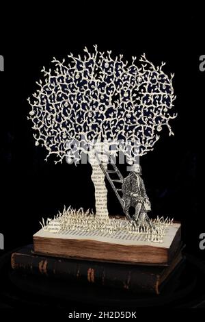 Sculpture de livre de Sir Isaac Newton assis sous l'arbre de pomme comme il découvre la gravité d'une pomme tombant de l'arbre. Banque D'Images