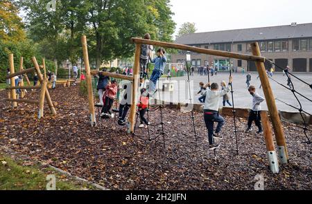 Muelheim an der Ruhr, Rhénanie-du-Nord-Westphalie, Allemagne - le jardin scolaire est ouvert, les enfants jouent sur le cadre d'escalade de la nouvelle cour d'école sont Banque D'Images