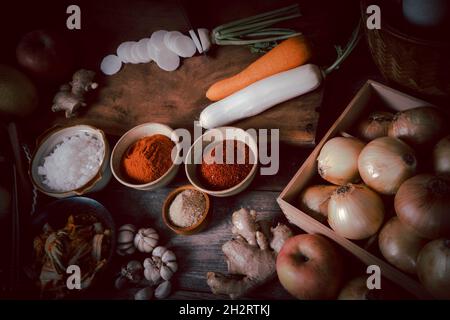 Ingrédients frais et légumes placés dans le tableau pour la fabrication de Kimchi qui contient des ingrédients tels que le gingembre, l'ail, le sel, l'oignon, le sucre, le gochugar Banque D'Images
