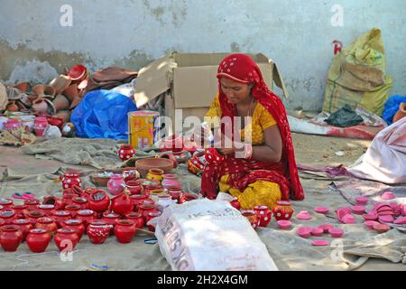 Beawar, Rajasthan, Inde, 23 octobre 2021 : une femme indienne prépare et vend des pots de terre sur un marché avant le festival hindou de Beawar.Crédit : Sumit Saraswat/Alay Live News Banque D'Images