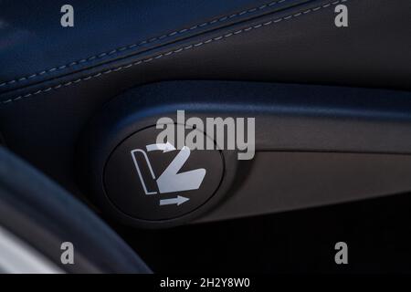 Bouton de rabattement de siège de deuxième rangée.Prise d'alimentation 12 V dans une voiture.Prise de courant dans une voiture. Banque D'Images