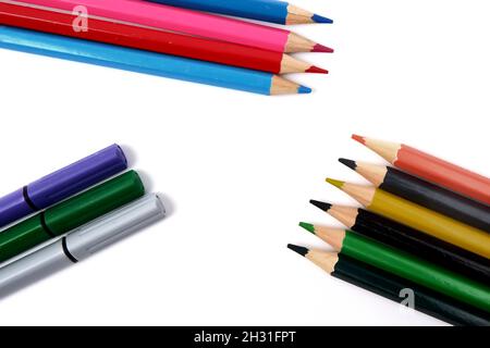 plusieurs crayons et marqueurs de couleur sur fond blanc. Banque D'Images