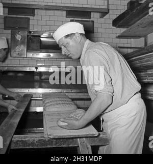 Ein Bäcker BEI seiner täglichen Arbeit, Deutschland 1950er Jahre.Un bakerman et son entreprise quotidienne, l'Allemagne des années 1950. Banque D'Images