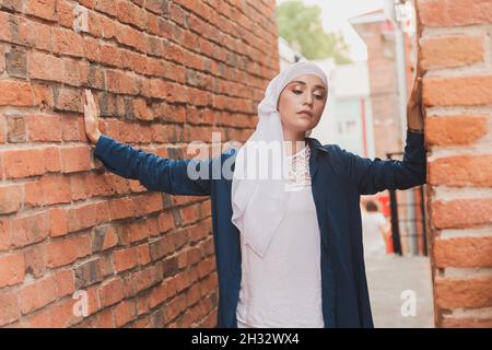 Mode moderne de fille musulmane avec hijab.magnifique modèle de femme musulmane portant hijab et tenue décontractée posant sur fond urbain Banque D'Images