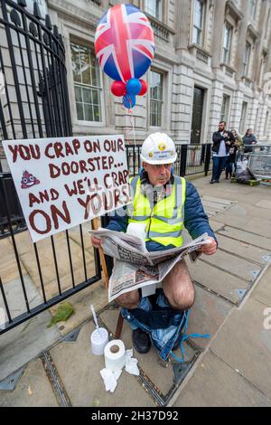 Londres, Royaume-Uni.26 octobre 2021.Steve Bray, un célèbre militant anti-Brexit, organise une manifestation devant Downing Street alors qu'il est assis dans des toilettes, ce qui attire l'attention sur l'impact des eaux usées non traitées dans les mers autour du Royaume-Uni et sur l'environnement.Sa manifestation est prévue avant la prochaine Conférence des Parties des Nations Unies sur les changements climatiques (COP26) qui se tiendra à Glasgow.Credit: Stephen Chung / Alamy Live News Banque D'Images