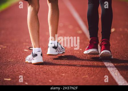 Le thème est le sport, le développement physique, la formation d'athlétisme pour les écoliers en cours d'éducation physique.Gros plan des jambes deux enfants garçon et fille Banque D'Images