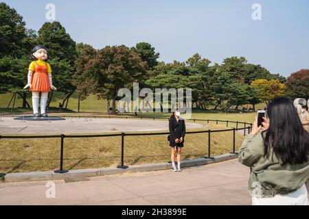 Séoul, Corée du Sud.26 octobre 2021.Les gens prennent des photos de la poupée géante de la série originale Netflix 'Squid Game' au parc olympique de Séoul.La poupée géante de la série originale Netflix 'Squid Game' est exposée au parc olympique de Séoul, en Corée du Sud, du 25 octobre au 23 janvier de l'année prochaine.Crédit : SOPA Images Limited/Alamy Live News Banque D'Images