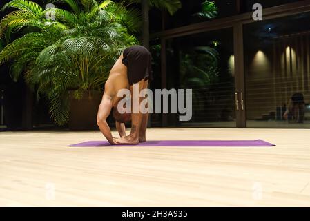Omar Mura homme caucasien d'âge moyen exécute une position de yoga à l'intérieur. Banque D'Images