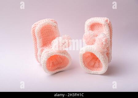 chaussures maison tricotées pour nouveau-né fille sur fond blanc Banque D'Images