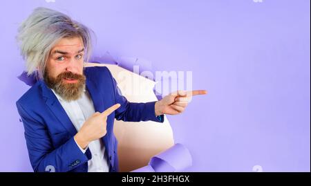 Homme d'affaires en costume pointant vers l'espace de copie.Publicité.Rabais, Vente, ventes saisonnières.Insérer du texte ou un slogan. Banque D'Images