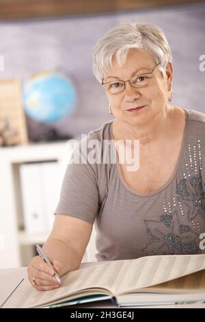 Professeur principal à l'école à la recherche dans un livre Banque D'Images