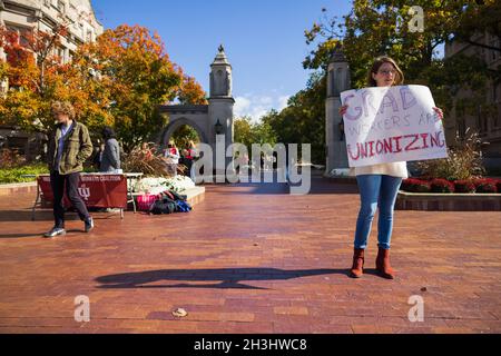 Bloomington, États-Unis.28 octobre 2021.Un membre de l'Indiana Grad Workers Coalition a une lecture de panneau, "Grad Workers are unionizing", lors de son dépôt à l'Indiana University Sample Gates à Bloomington.l'IGWC (Indiana Grad Workers Coalition) tente actuellement d'organiser un syndicat pour les employés diplômés de l'Indiana University.Crédit : SOPA Images Limited/Alamy Live News Banque D'Images