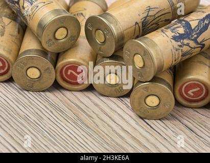 Cartouches de chasse calibre 12 pour fusil de chasse sur fond de bois. Un plan macro. Banque D'Images