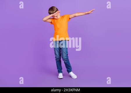 Pleine longueur corps photo garçon dans une tenue élégante danse montrant le signe dab isolé couleur pastel violet fond Banque D'Images