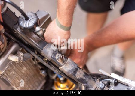 Mécanicien de moto, remplacement du radiateur de refroidissement.Remplacement ou entretien du radiateur. Banque D'Images