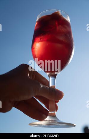 Sangria servi à la main avec du vin rouge dans un verre Banque D'Images