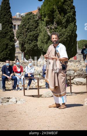 CATALOGNE, ESPAGNE - 8 MAI 2021 : guide touristique en vêtements anciens authentiques dans les vestiges archéologiques des anciens Empuries de la ville antique.Musée Archéologique de Catal Banque D'Images