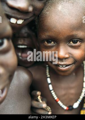 Tribu TOPOSA, SOUDAN DU SUD - 12 MARS 2020 : les enfants de la tribu Toposa sourient et regardent la caméra tout en jouant ensemble dans le mal Banque D'Images