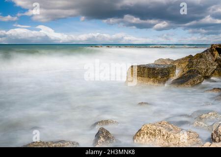 Falaises dans la mer Adriatique.Les rayons du soleil se réfléchit sur les rochers.Exposition longue. Banque D'Images