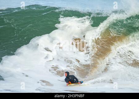 Surf à Portrush comme une grosse tempête de vague arrive au large de l'océan Atlantique et atteint la côte d'Antrim, en Irlande du Nord. Banque D'Images