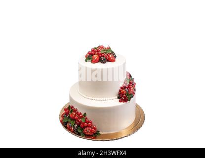 Délicieux gâteau blanc à deux niveaux, décoré de baies et de fruits.Sur un arrière-plan blanc isolé.Copier l'espace Banque D'Images