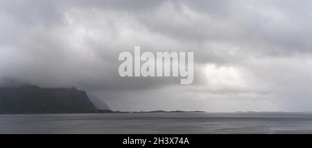 Panorama d'un fjord mystique et de l'océan Atlantique lors d'une journée d'été trouble et brumeuse dans les îles Lofoten, au nord de la Norvège Banque D'Images